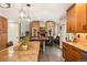 Open-concept kitchen with wood cabinets flows into the dining and living areas at 9407 Dolton Way, Highlands Ranch, CO 80126