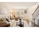 Inviting living room with hardwood floors, a cozy seating area, and natural light, perfect for relaxing or entertaining guests at 9407 Dolton Way, Highlands Ranch, CO 80126