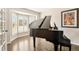 Elegant living room featuring a grand piano and a bay window, creating a bright and inviting atmosphere at 9407 Dolton Way, Highlands Ranch, CO 80126