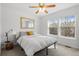 Bright bedroom with a ceiling fan, large windows, and neutral-toned decor for a relaxing atmosphere at 1457 S Pierce St, Lakewood, CO 80232