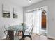 Bright dining area featuring a mosaic-style glass table and access to an outdoor patio through sliding glass doors at 1457 S Pierce St, Lakewood, CO 80232