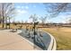 Exercise equipment in a neighborhood park with mature trees at 1457 S Pierce St, Lakewood, CO 80232