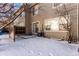 Small backyard with a patio and snow covering the ground at 15907 E 13Th Ave, Aurora, CO 80011