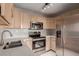 Modern kitchen featuring stainless steel appliances and light wood cabinets at 15907 E 13Th Ave, Aurora, CO 80011