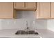 Clean kitchen sink with double basin and light gray backsplash at 15907 E 13Th Ave, Aurora, CO 80011