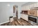 Kitchen offers ample cabinet space, stainless steel appliances, and brick accent wall at 1120 N Norfolk St, Aurora, CO 80011