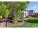 A lovely backyard featuring green lawn and a pergola, partially covered in greenery, attached to the house at 16553 Gilpin St, Thornton, CO 80602