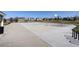 Community basketball court surrounded by green space and trees on a sunny day at 16553 Gilpin St, Thornton, CO 80602