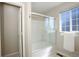 Clean bathroom featuring a glass-enclosed shower and a window at 16553 Gilpin St, Thornton, CO 80602