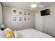 Relaxing bedroom with a ceiling fan, natural lighting, decorative wall art, and TV at 16553 Gilpin St, Thornton, CO 80602