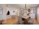 Bright dining area with wood floors, chandelier, seating for six, and built-in storage at 16553 Gilpin St, Thornton, CO 80602