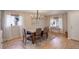 Inviting dining room featuring wood floors, modern lighting, and an abundance of natural light at 16553 Gilpin St, Thornton, CO 80602