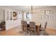 Dining room showcasing hardwood floors, ample built in storage, and stylish chandelier at 16553 Gilpin St, Thornton, CO 80602