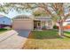 Charming home featuring a stone facade, two-car garage, inviting front porch and a well-manicured lawn at 16553 Gilpin St, Thornton, CO 80602