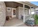 Inviting front porch with stone accents, decorative details and a cozy sitting area at 16553 Gilpin St, Thornton, CO 80602