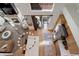 Well-lit kitchen featuring stainless steel appliances, hardwood floors, island lighting, and patio access at 16553 Gilpin St, Thornton, CO 80602
