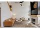 The living room is well-lit with neutral colored walls, carpet, and a stone fireplace at 16553 Gilpin St, Thornton, CO 80602