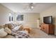 Large, well-lit room with neutral color walls, carpeted floors, and a view of the windows at 16553 Gilpin St, Thornton, CO 80602