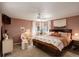 Inviting main bedroom featuring a comfortable bed, ample natural light, and stylish decor at 16553 Gilpin St, Thornton, CO 80602