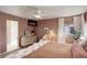 Spacious main bedroom with large bed, natural light, and ensuite bathroom access at 16553 Gilpin St, Thornton, CO 80602