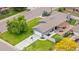 Aerial view of home featuring a long driveway, backyard patio, and mature trees on a large lot at 7155 E Exposition Ave, Denver, CO 80224