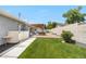 This backyard features a well-manicured lawn, brick patio and a cozy pergola with outdoor seating at 7155 E Exposition Ave, Denver, CO 80224