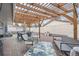 Backyard patio with pergola featuring dining area and lounge area with bench at 7155 E Exposition Ave, Denver, CO 80224