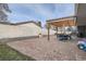 Backyard patio with pergola featuring dining area and lounge area with bench at 7155 E Exposition Ave, Denver, CO 80224