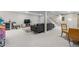 Spacious finished basement with a wet bar, comfortable seating, and ample lighting at 7155 E Exposition Ave, Denver, CO 80224