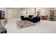 Spacious finished basement with plush carpeting, sectional sofa, and entertainment area at 7155 E Exposition Ave, Denver, CO 80224