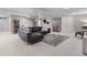Large basement with cozy seating area, plush rug, and versatile layout at 7155 E Exposition Ave, Denver, CO 80224