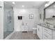 Clean and modern bathroom with a glass shower, granite vanity, and neutral color scheme at 7155 E Exposition Ave, Denver, CO 80224