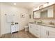 Stylish bathroom featuring granite countertops, a double vanity, and sleek fixtures at 7155 E Exposition Ave, Denver, CO 80224