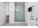 Contemporary bathroom with a frameless glass shower, modern fixtures, and ample storage at 7155 E Exposition Ave, Denver, CO 80224
