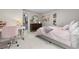 Inviting bedroom featuring a dresser, comfortable bed, and charming decor at 7155 E Exposition Ave, Denver, CO 80224