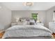 Comfortable bedroom with a soft bed, elegant chandelier, and natural light at 7155 E Exposition Ave, Denver, CO 80224