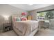 Charming bedroom with a cozy bed, desk, and natural light from the window at 7155 E Exposition Ave, Denver, CO 80224