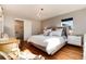 Bedroom with hardwood floors, a statement chandelier, and a bathroom en suite at 7155 E Exposition Ave, Denver, CO 80224