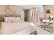 Charming bedroom features stylish decorations, soft carpet, a desk, and lots of natural light at 7155 E Exposition Ave, Denver, CO 80224