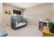 Neutral toned Bedroom features a crib, bookshelf, and a window with blackout shade at 7155 E Exposition Ave, Denver, CO 80224