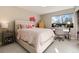 Bedroom with a full bed, side tables, desk, chair and a large window with natural light at 7155 E Exposition Ave, Denver, CO 80224