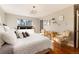 Bright bedroom with hardwood floors, many pillows, and a chandelier at 7155 E Exposition Ave, Denver, CO 80224