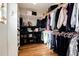 Spacious walk-in closet featuring custom shelving and ample storage for clothing and shoes at 7155 E Exposition Ave, Denver, CO 80224