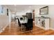 Dining room features hardwood floors with views into the modern kitchen at 7155 E Exposition Ave, Denver, CO 80224