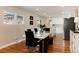 Bright dining room features a modern table, black chairs, and direct access to the kitchen at 7155 E Exposition Ave, Denver, CO 80224