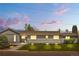 Charming single-story home featuring a well-maintained lawn and a freshly painted gray exterior at 7155 E Exposition Ave, Denver, CO 80224