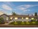 Charming single-story home featuring a well-maintained lawn and a freshly painted gray exterior at 7155 E Exposition Ave, Denver, CO 80224