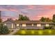 Charming single-story home with a manicured lawn and beautiful twilight sky at 7155 E Exposition Ave, Denver, CO 80224