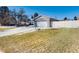 Home exterior featuring a spacious driveway, garage, and well-maintained lawn at 7155 E Exposition Ave, Denver, CO 80224