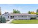 Charming home with well-manicured lawn, updated exterior paint, and inviting landscaping for curb appeal at 7155 E Exposition Ave, Denver, CO 80224